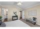 The carpeted bedroom includes neutral walls, fan, queen bed and easy access to the ensuite bathroom at 3968 Ashcroft Ave, Castle Rock, CO 80104