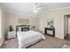 Carpeted bedroom featuring light tan walls, overhead fan and a comfortable queen-sized bed at 3968 Ashcroft Ave, Castle Rock, CO 80104