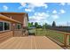 A wooden deck with dark railing and steps leading down to a backyard with a gazebo at 3968 Ashcroft Ave, Castle Rock, CO 80104
