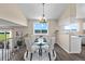 Dining area with glass table, white chairs, modern chandelier, and natural light at 3968 Ashcroft Ave, Castle Rock, CO 80104