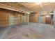 Large garage featuring unfinished walls, an insulated garage door, and side entry door at 3968 Ashcroft Ave, Castle Rock, CO 80104