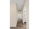 Hallway with wood floors and light-colored walls showing a view of the living room and bathroom at 3968 Ashcroft Ave, Castle Rock, CO 80104