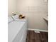 Functional laundry area with wood-look flooring, shelving, and a side-by-side washer and dryer at 3968 Ashcroft Ave, Castle Rock, CO 80104