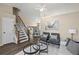 Open-concept living area with hardwood floors, stairs, and views into the dining area at 3968 Ashcroft Ave, Castle Rock, CO 80104