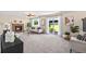 Carpeted living room with brick fireplace, sofas, and sliding glass doors to backyard at 3968 Ashcroft Ave, Castle Rock, CO 80104