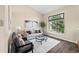 Bright living room with vaulted ceilings, elegant decor, and a large window overlooking lush greenery at 3968 Ashcroft Ave, Castle Rock, CO 80104