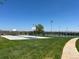 Outdoor basketball and tennis courts offer recreational opportunities in a well-maintained, grassy area under a clear sky at 10064 Owens St, Broomfield, CO 80021