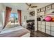 Bedroom featuring a desk and closet area, a bed, and exterior natural light at 10064 Owens St, Broomfield, CO 80021