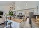 Bright open concept kitchen featuring an island with tile countertops, stainless steel appliances and open to the living room at 10064 Owens St, Broomfield, CO 80021