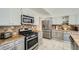 Bright open concept kitchen featuring stainless steel appliances and tile countertops at 10064 Owens St, Broomfield, CO 80021