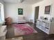 Cozy living room with hardwood floors, a decorative rug, and ample natural light at 10064 Owens St, Broomfield, CO 80021