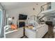 Bright living room featuring vaulted ceiling, brick fireplace and open staircase at 10064 Owens St, Broomfield, CO 80021