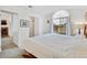 Comfortable bedroom with a vaulted ceiling and large arched window at 8757 E Dry Creek Rd # 1528, Englewood, CO 80112