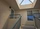 Exterior entrance stairs to unit feature a skylight and house number 1528 for easy identification at 8757 E Dry Creek Rd # 1528, Englewood, CO 80112