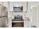 Modern kitchen with stainless steel oven and microwave at 8757 E Dry Creek Rd # 1528, Englewood, CO 80112