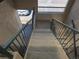 Exterior staircase leading up to the property, featuring sturdy railings and textured walls at 8757 E Dry Creek Rd # 1528, Englewood, CO 80112