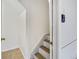 Bright stairwell with white walls and carpeted stairs leading to the upper level at 8757 E Dry Creek Rd # 1528, Englewood, CO 80112