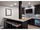 Charming basement wet bar with seating and granite countertops for entertaining in this lovely home at 10601 Montecito Dr, Lone Tree, CO 80124