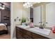 Bathroom vanity with double sinks, framed mirror, and decorative tile backsplash at 10601 Montecito Dr, Lone Tree, CO 80124