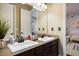 Bathroom vanity with double sinks, framed mirror, and decorative tile backsplash at 10601 Montecito Dr, Lone Tree, CO 80124