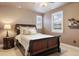 Bedroom with black sleigh bed, side table, and window with plantation shutters at 10601 Montecito Dr, Lone Tree, CO 80124