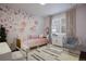 Bedroom with pink accents and flower wall art; includes a writing desk and hanging chair at 10601 Montecito Dr, Lone Tree, CO 80124
