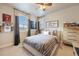 Cozy bedroom with neutral tones, a ceiling fan, comfortable bed, and stylish decor at 10601 Montecito Dr, Lone Tree, CO 80124