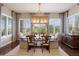 Inviting dining room with a modern chandelier and large windows at 10601 Montecito Dr, Lone Tree, CO 80124