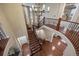 Grand foyer with hardwood floors, curved staircase, and elegant chandelier at 10601 Montecito Dr, Lone Tree, CO 80124
