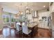 Open-concept kitchen featuring a large island, stainless steel appliances, and stylish pendant lighting at 10601 Montecito Dr, Lone Tree, CO 80124