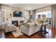 Bright living room with a fireplace, comfortable seating, and natural light at 10601 Montecito Dr, Lone Tree, CO 80124