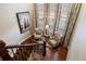 Comfortable living room nook with hardwood floors, plantation shutters, and lots of natural light at 10601 Montecito Dr, Lone Tree, CO 80124