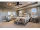 Main bedroom with wood ceiling, neutral color palette, sitting area, and natural light at 10601 Montecito Dr, Lone Tree, CO 80124