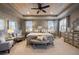 Main bedroom with wood ceiling, neutral color palette, sitting area, and natural light at 10601 Montecito Dr, Lone Tree, CO 80124