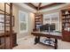 Home office with custom shelves, a modern desk, and plenty of natural light at 10601 Montecito Dr, Lone Tree, CO 80124