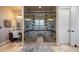 Tiled shower room with dual shower heads, glass doors, and separate vanity area at 10601 Montecito Dr, Lone Tree, CO 80124