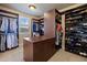 Organized walk-in closet with custom shelving and hanging storage for clothes and shoes at 10601 Montecito Dr, Lone Tree, CO 80124