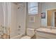 Bathroom with shower/tub combo, granite vanity, and a single sink offering a functional and stylish space at 6612 N Ceylon St, Denver, CO 80249
