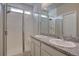 Bathroom featuring a granite countertop with dual sinks and a glass-enclosed shower, offering a spa-like experience at 6612 N Ceylon St, Denver, CO 80249