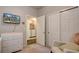 Bedroom featuring a dresser with a TV, closet, and laundry area, combining comfort and convenience at 6612 N Ceylon St, Denver, CO 80249