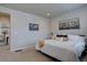 Bright bedroom with a large bed, neutral walls, and decorative artwork creates a calm and inviting space at 6612 N Ceylon St, Denver, CO 80249