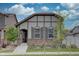 Charming home featuring stone accents, neutral colors, and a well-manicured front yard under a partly cloudy sky at 6612 N Ceylon St, Denver, CO 80249