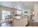 Open kitchen with granite countertops, a kitchen island, stainless appliances, and dining area at 6612 N Ceylon St, Denver, CO 80249
