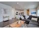 Bright, open living area with wood floors, modern decor, and seamless flow into a well-equipped kitchen at 6612 N Ceylon St, Denver, CO 80249