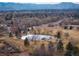 A scenic aerial view shows a charming park with a pond, playground, and walking trails near the property at 1492 S Dudley St, Lakewood, CO 80232