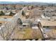 An aerial view of a neighborhood showcasing a home with a lush backyard and a concrete patio at 1492 S Dudley St, Lakewood, CO 80232