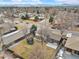 A bird's eye view shows the property's expansive backyard with a trampoline and concrete patio at 1492 S Dudley St, Lakewood, CO 80232