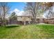 Expansive backyard with lush grass, a trampoline, and patio, perfect for outdoor activities and entertaining at 1492 S Dudley St, Lakewood, CO 80232