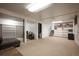 Spacious finished basement with built-in shelving, carpeted floors, and versatile layout at 1492 S Dudley St, Lakewood, CO 80232