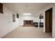 Finished basement area with a brick fireplace and comfortable seating, offering a cozy gathering space at 1492 S Dudley St, Lakewood, CO 80232